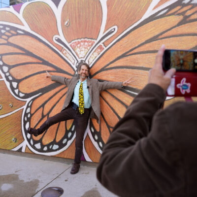 Robert Opel poses for a photo on Oct. 19 in front of his mural, “Wings of Joy,” which was the winning artwork for The Catholic Foundation’s 2022 Art On The Plaza competition. The mural will remain on display for one year in The Catholic Foundation Plaza, located behind the Cathedral Shrine of the Virgin of Guadalupe in the downtown Dallas Arts District. (Michael Gresham/The Texas Catholic)