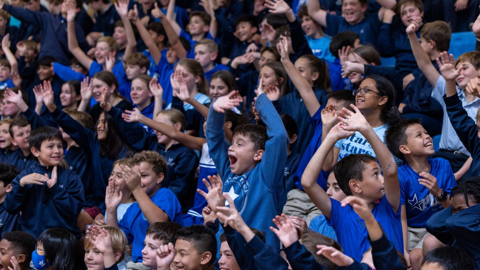 young students celebrating in the stands